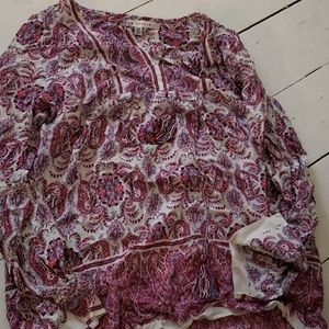 A multicoloured blouse very flowy and never worn.